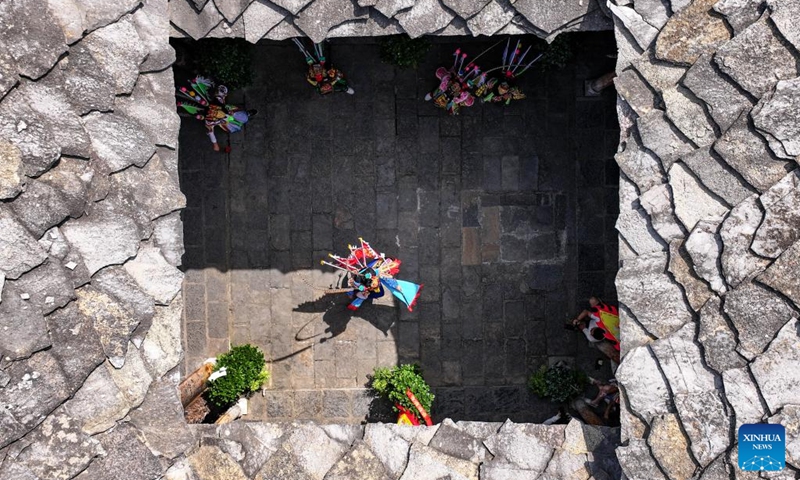 An aerial drone photo shows young Dixi opera enthusiasts staging a performance in Pingba District of Anshun City, southwest China's Guizhou Province, July 25, 2024. Anshun Dixi Opera is an important part of Tunpu culture dating back to the Ming Dynasty (1368-1644). The opera has been listed as one of the national intangible cultural heritages in 2006. Photo: Xinhua