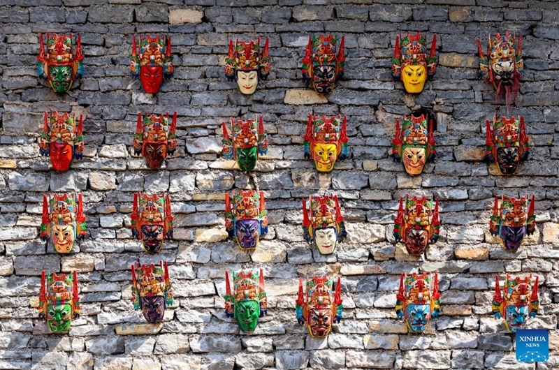 Dixi masks are seen on a wall in Pingba District of Anshun City, southwest China's Guizhou Province, July 25, 2024. Photo: Xinhua