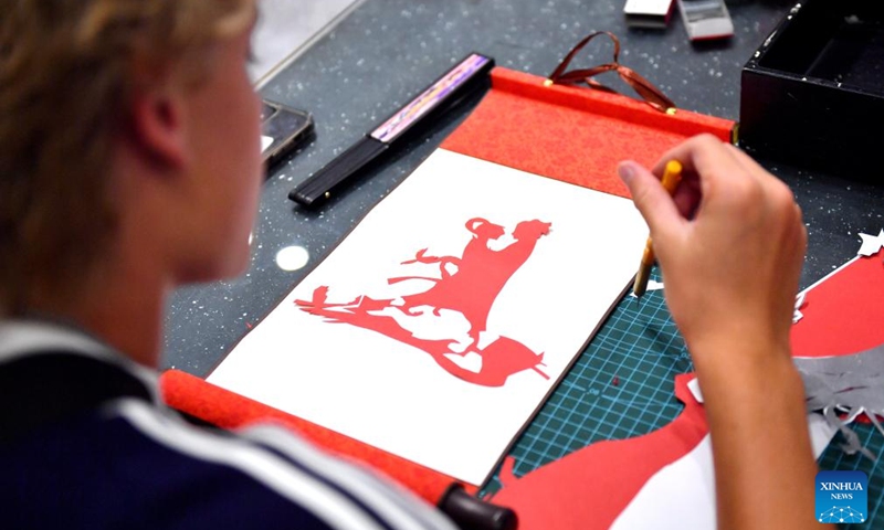 An American student makes a paper cut work featuring the Qixi Festival during a cultural event at Shijiazhuang Foreign Language School in Shijiazhuang, north China's Hebei Province, Aug. 10, 2024. A delegation of middle school students and teachers from US state Iowa took part in a cultural event here on the occasion of the Qixi Festival, also known as Chinese Valentine's Day. Photo: Xinhua