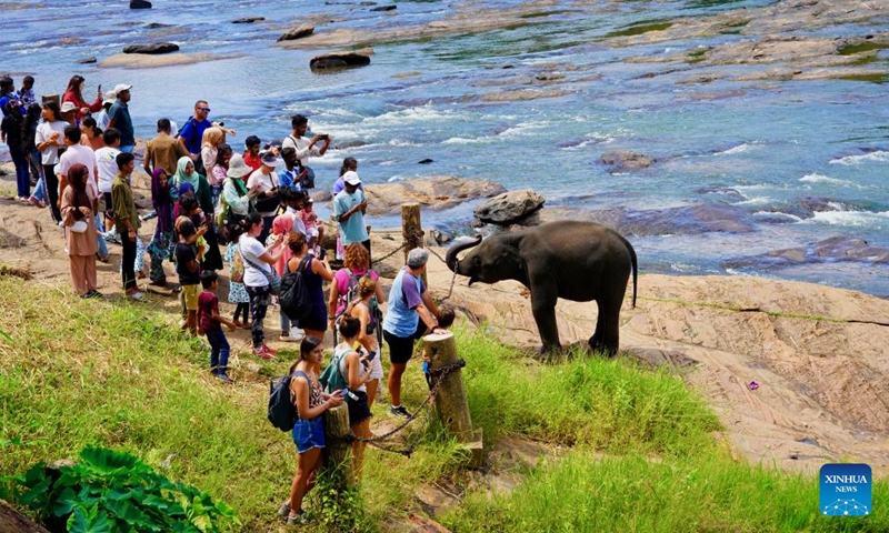 Tourists interact with an elephant at the Pinnawala Elephant Orphanage in Sri Lanka, Aug. 11, 2024. Established in 1975, Pinnawala Elephant Orphanage is the first one of its kind in the world, home to 69 elephant orphans today. The World Elephant Day falls on Aug. 12 each year. Photo: Xinhua