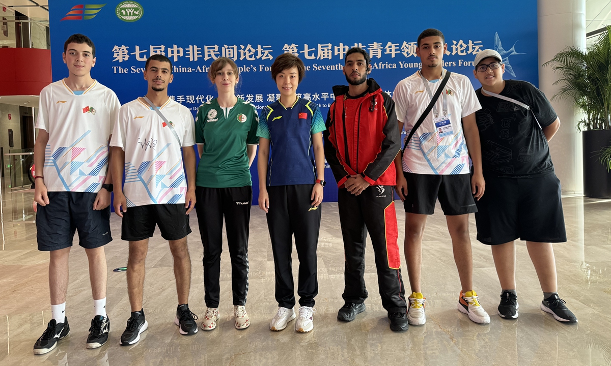 Algerian table tennis player Amdjed Oustani (second from right) poses for a group photo with world champion Zhang Yining (center) and other international table tennis players during the 7th China-Africa People's Forum in July, 2024. Photo: Courtesy of China Table Tennis College