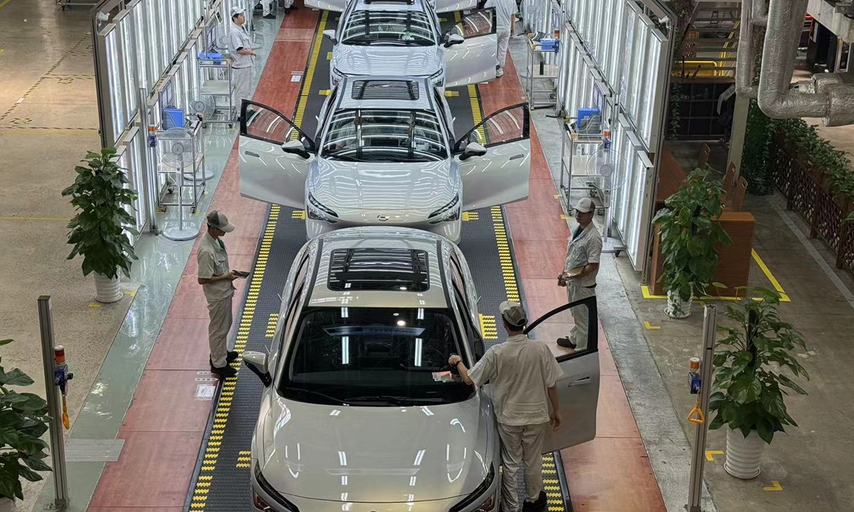 Workers complete the final assembly work of new energy vehicles at GAC AION Smart Ecological Factory in Panyu district of Guangzhou, South China's Guangdong Province on July 18, 2024. Photo: Tu Lei/GT