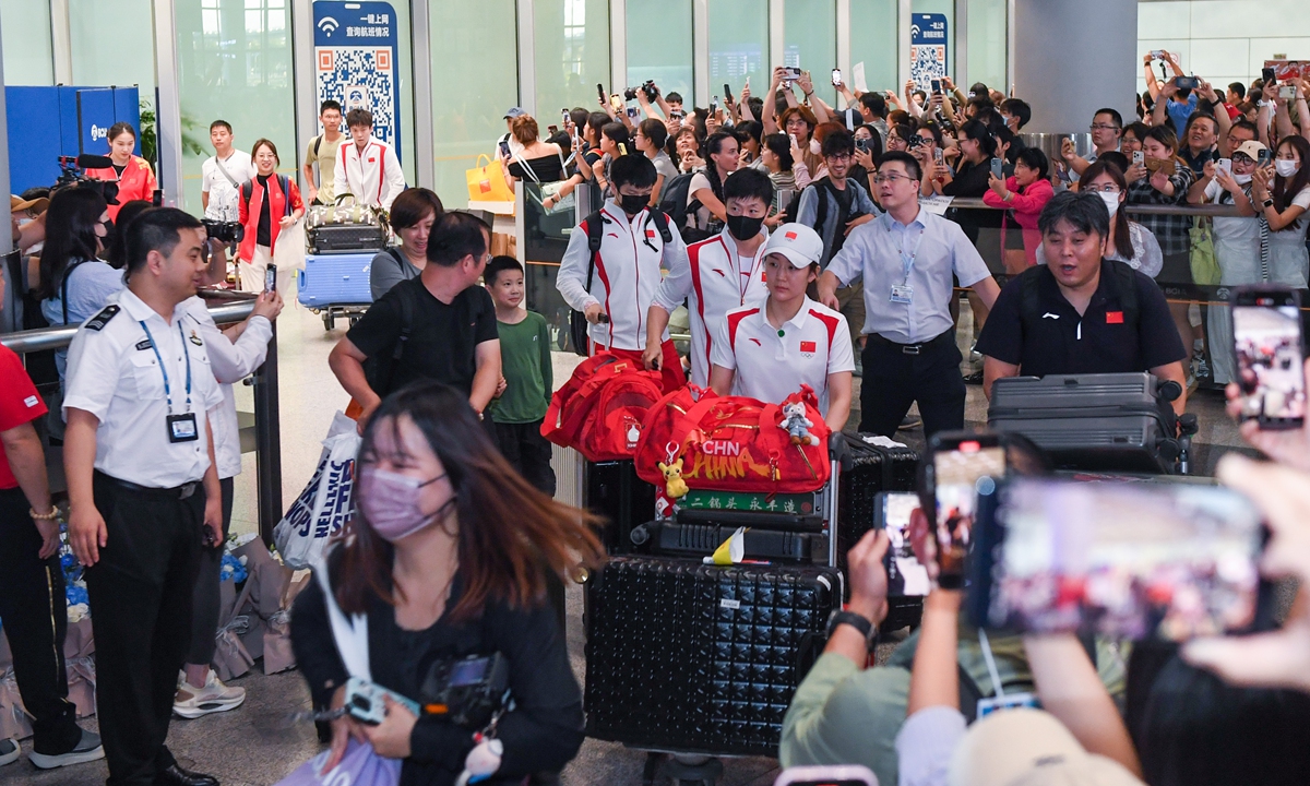 Athletes from the Team China delegation arrive at the Capital International Airport in Beijing and are greeted by fans as they return home from the Paris Olympic Games on August 12, 2024. Photo: VCG