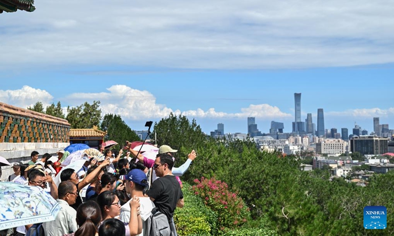 Tourists have fun in Jingshan Park on a sunny day in Beijing, capital of China, Aug. 12, 2024. （Photo: Xinhua)