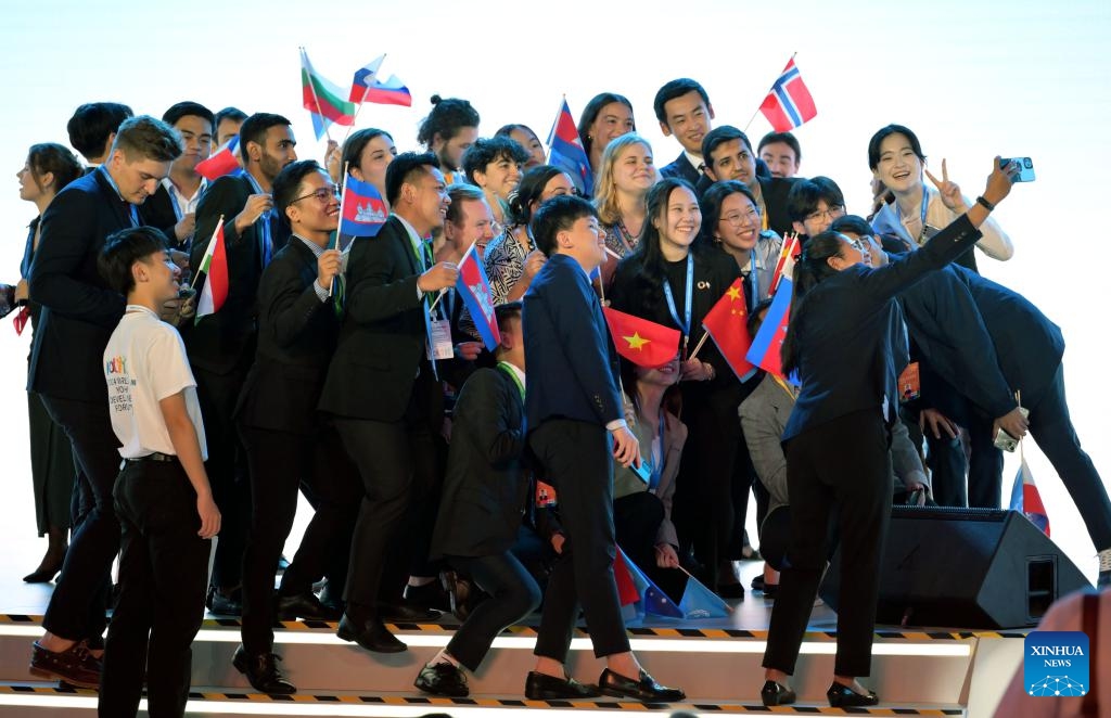 Participants take a group photo ahead of the opening ceremony of the 2024 World Youth Development Forum in Beijing, capital of China, Aug. 12, 2024.（Photo: Xinhua)