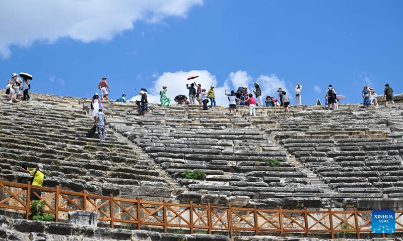 Tourists visit the ruins of the ancient city of Hierapolis in Denizli, Türkiye, Aug. 11, 2024. Hierapolis is a UNESCO World Heritage Site. （Photo: Xinhua)