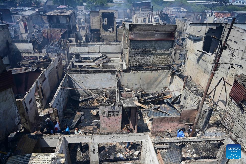 Residents walk among charred houses after a fire at densely populated area in Manggarai of Jakarta, Indonesia, Aug. 13, 2024. (Photo: Xinhua)