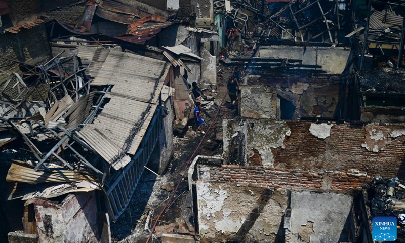 Residents walk among charred houses after a fire at densely populated area in Manggarai of Jakarta, Indonesia, Aug. 13, 2024. (Photo: Xinhua)