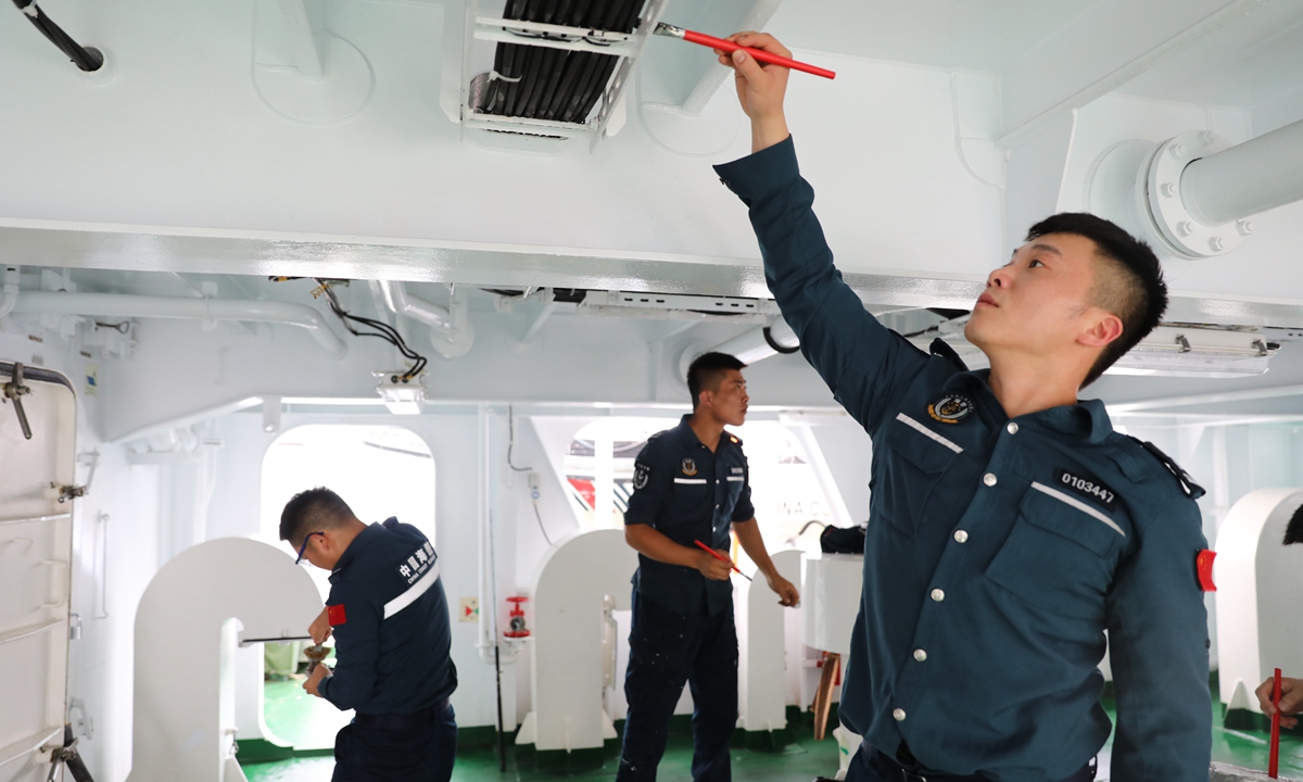 CCG officers carry out equipment maintenance on the rear deck of the <em>Wanshan</em>, on July 18, 2024. Photo: Lin Xiaoyi/GT