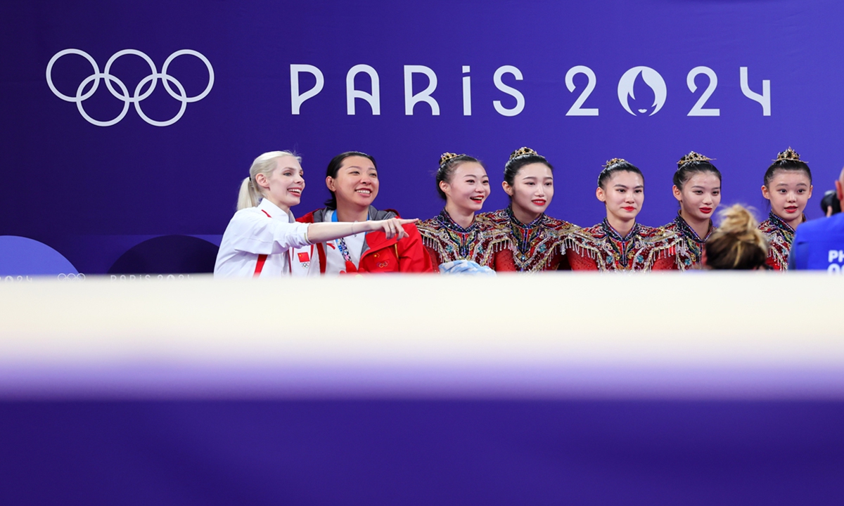 The<strong></strong> Chinese rhythmic gymnastics team sit with their Russian coach Anastasia Bliznyuk at the 2024 Paris Olympic Games, on August 10, 2024. Photo: VCG