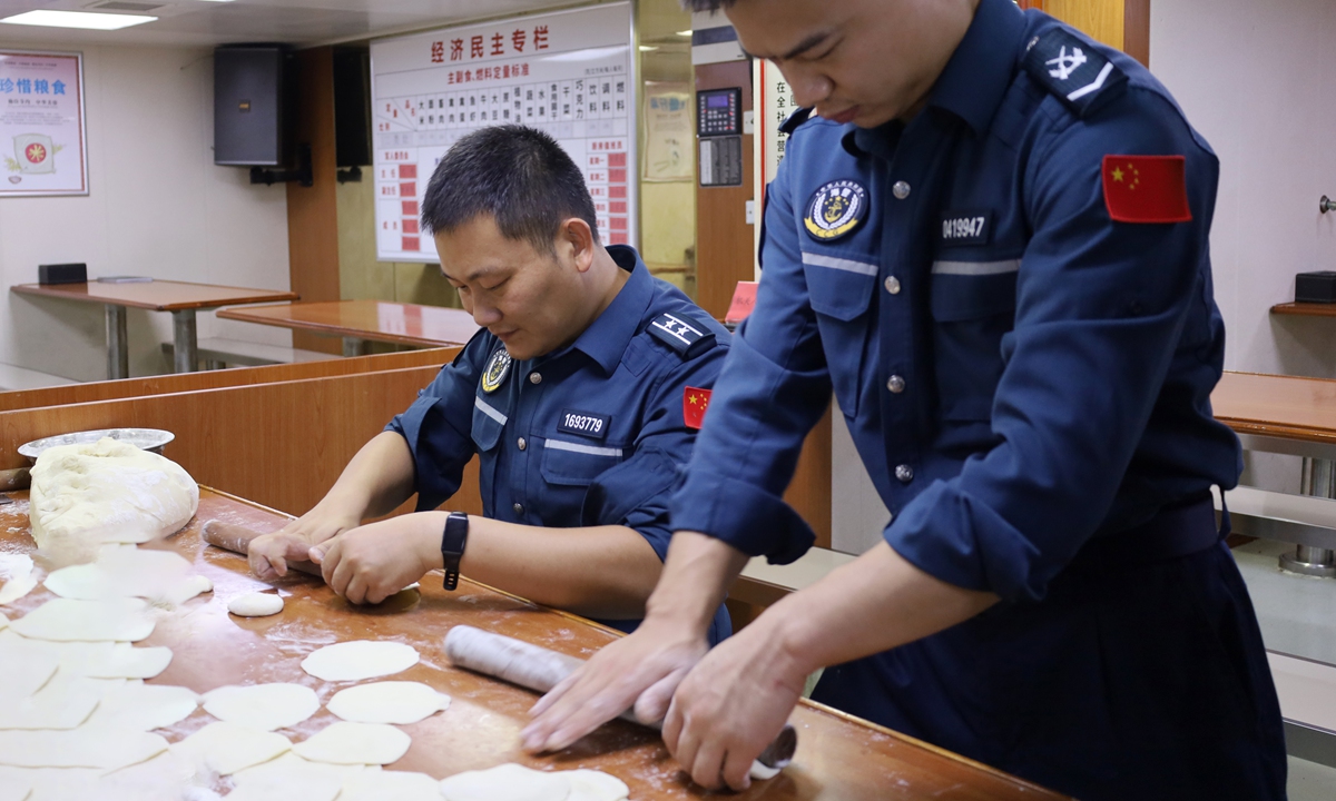 CCG officers aboard the <em>Wanshan</em>make dumplings at the canteen during their mission patrolling in the waters off Huangyan Dao, on June 28, 2024. Photo: Courtesy of China Coast Guard