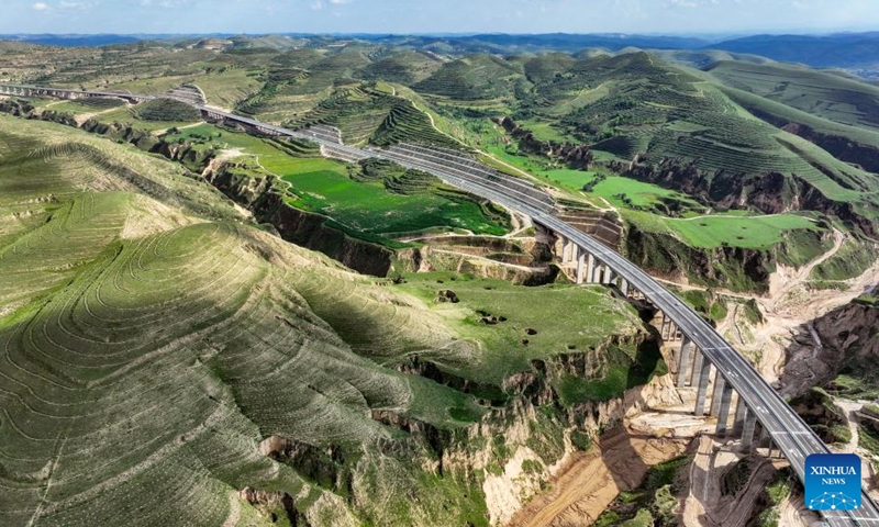 This aerial drone photo taken on Aug. 16, 2024 shows vehicles running along the Yinchuan-Kunming highway in northwest China's Ningxia Hui Autonomous Region. A section of the Yinchuan-Kunming highway within Ningxia, from Taiyangshan development zone to Pengyang, was completed and opened to traffic on Friday, marking the full opening of the Yinchuan-Kunming highway. The highway linking Yinchuan of northwest China's Ningxia Hui Autonomous Region and Kunming of southwest China's Yunnan Province, spans 2322 kilometers. 
Photo: Xinhua