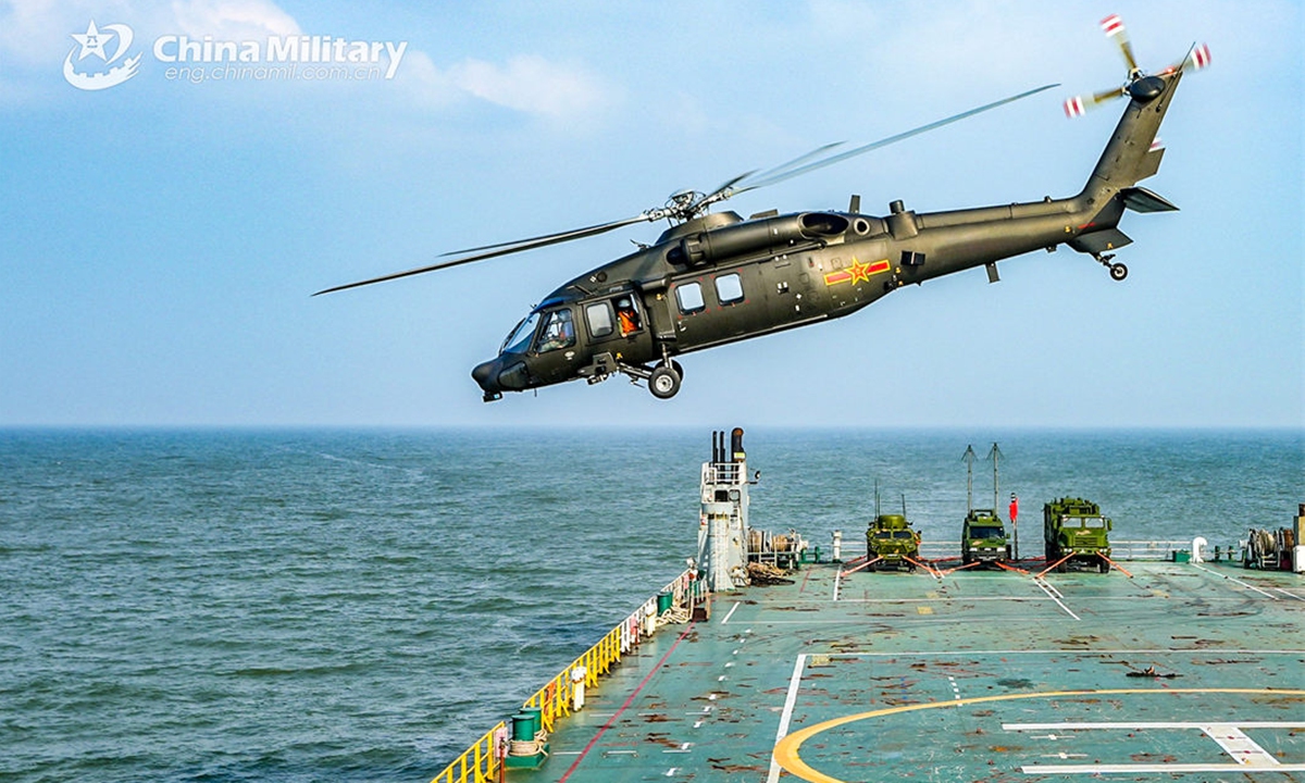 A helicopter attached to a brigade under the PLA 71st Group Army takes off from a maritime platform during a flight training exercise on July 3,<strong></strong> 2024. (eng.chinamil.com.cn/Photo by Li Jingyou)