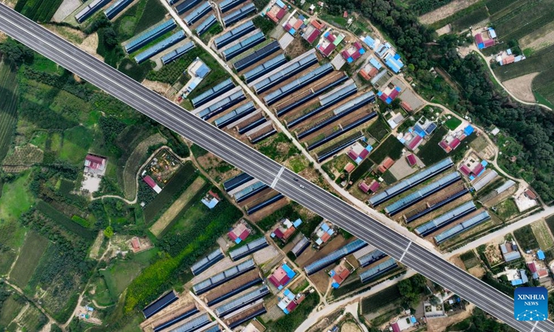 This aerial drone photo taken on Aug. 16, 2024 shows vehicles running along the Yinchuan-Kunming highway in northwest China's Ningxia Hui Autonomous Region. A section of the Yinchuan-Kunming highway within Ningxia, from Taiyangshan development zone to Pengyang, was completed and opened to traffic on Friday, marking the full opening of the Yinchuan-Kunming highway. The highway linking Yinchuan of northwest China's Ningxia Hui Autonomous Region and Kunming of southwest China's Yunnan Province, spans 2322 kilometers. Photo: Xinhua