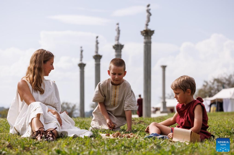 Young participants dressed in Roman costumes play tropa, a children game with nuts, during the Roman Games in Ptuj, Slovenia, Aug. 17, 2024. The Roman Games, one of the largest presentations of the Roman period in Slovenia, was held in Ptuj on Saturday. Photo: Xinhua