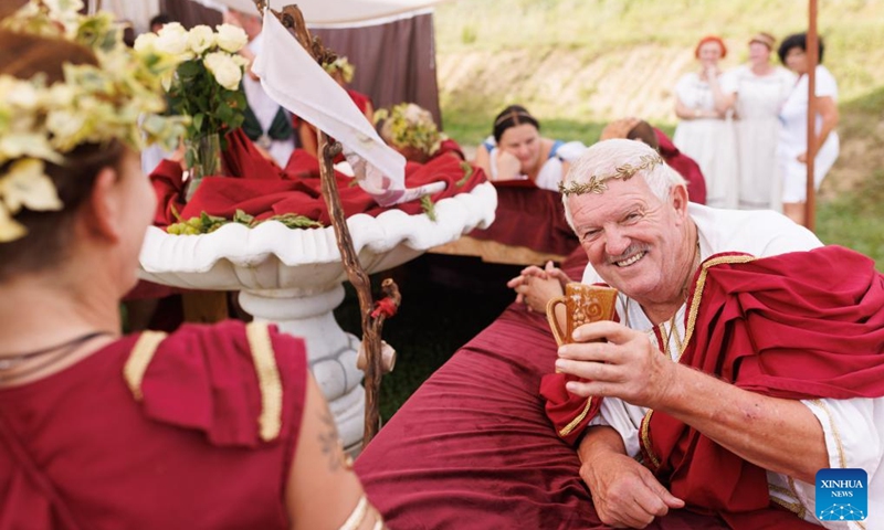 A participant dressed in Roman costume enjoys wine during the Roman Games in Ptuj, Slovenia, Aug. 17, 2024. The Roman Games, one of the largest presentations of the Roman period in Slovenia, was held in Ptuj on Saturday. Photo: Xinhua