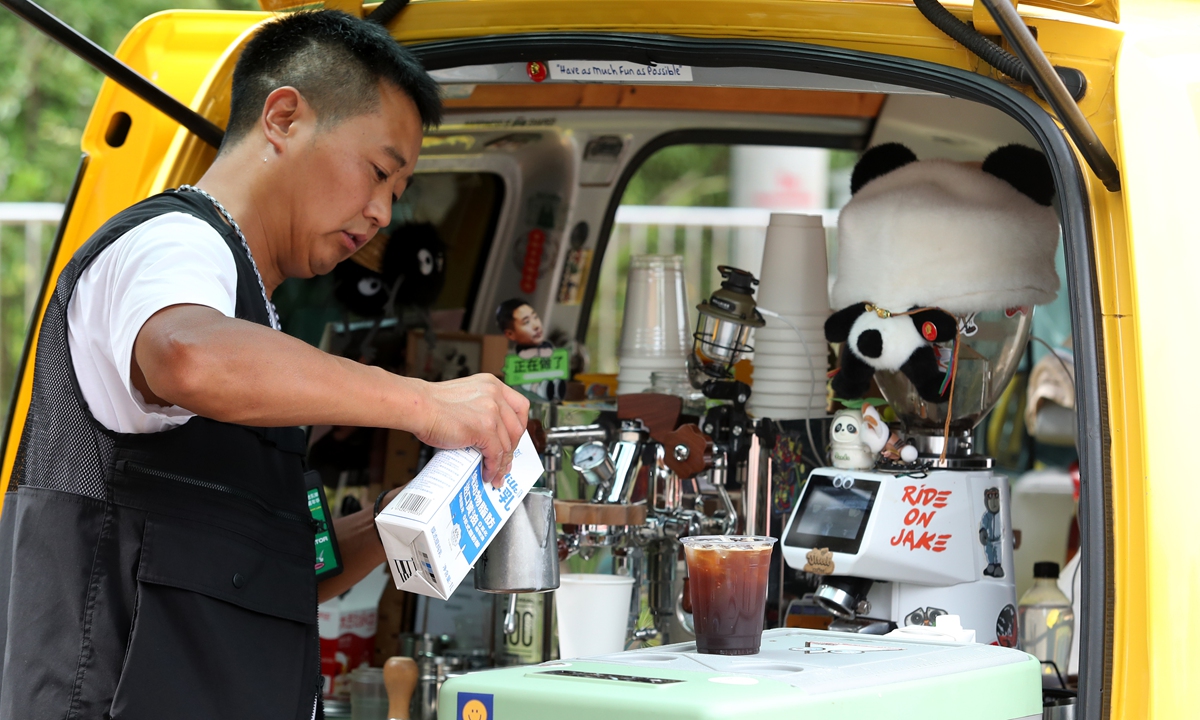 A man uses coffee machines to brew up some cups on a traveling van at a coffee culture fair in Kunming, Southwest China's Yunnan Province on August 18, 2024. The province accounts for 98 percent of the country's coffee output, benefiting more than 600,000 growers, according to media reports. Photo: VCG