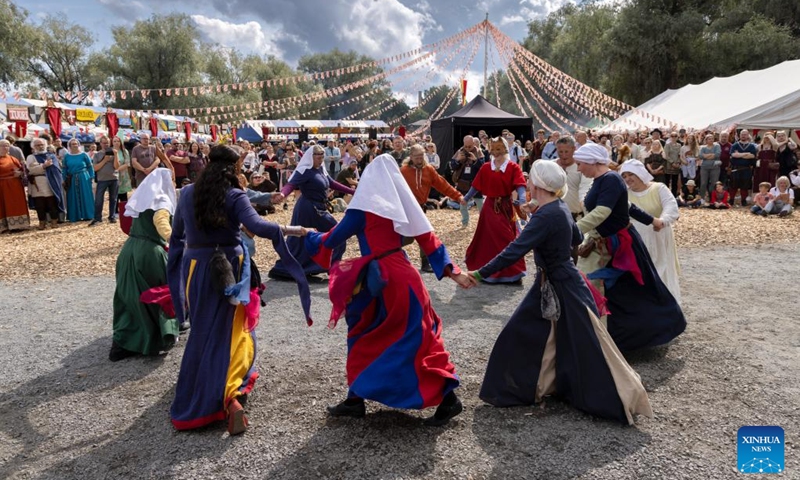 Reenactors perform medieval dances during the Hame Medieval Festival in Hameenlinna, Finland on Aug. 17, 2024. The southern Finnish city of Hameenlinna hosted the Hame Medieval Festival, one of Finland's largest historical festivals, on the picturesque lakeside meadow beside Hame Castle from Aug. 16 to 18. Photo: Xinhua