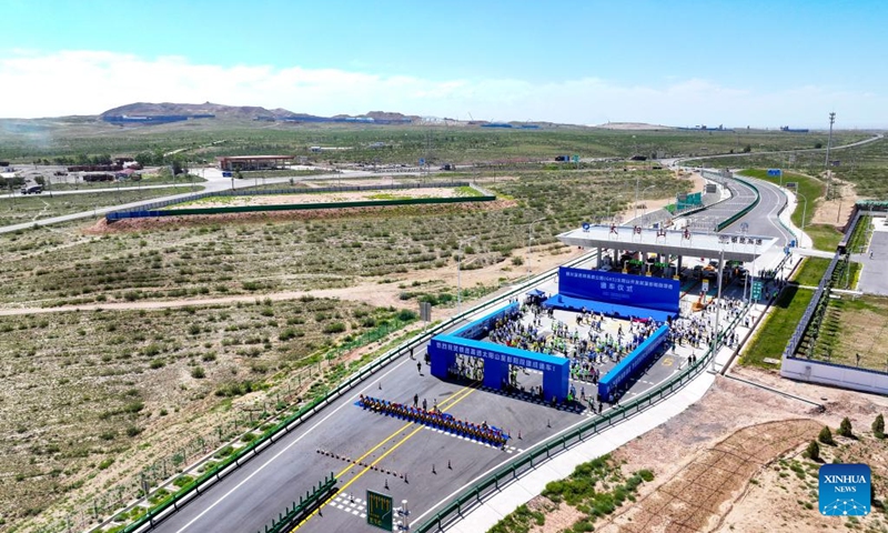 This aerial drone photo taken on Aug. 16, 2024 shows a view of the opening ceremony of the Yinchuan-Kunming highway at the Taiyangshan south toll gate in northwest China's Ningxia Hui Autonomous Region. A section of the Yinchuan-Kunming highway within Ningxia, from Taiyangshan development zone to Pengyang, was completed and opened to traffic on Friday, marking the full opening of the Yinchuan-Kunming highway. The highway linking Yinchuan of northwest China's Ningxia Hui Autonomous Region and Kunming of southwest China's Yunnan Province, spans 2322 kilometers. Photo: Xinhua