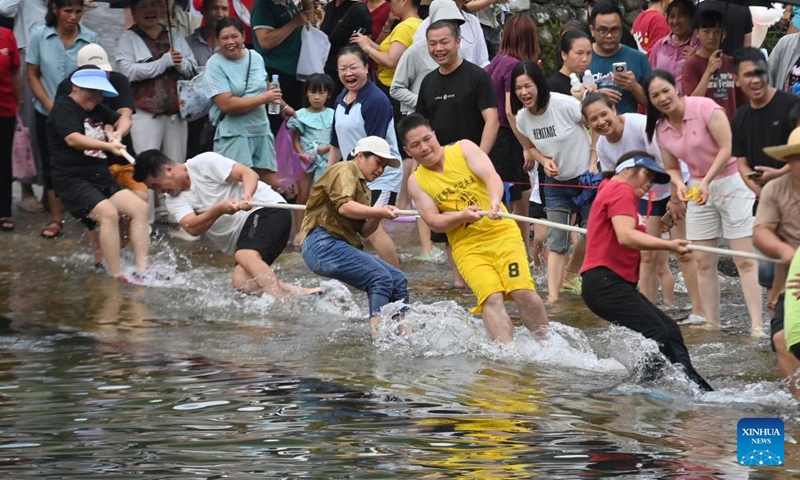 Villagers take part in a tug-of-war contest in Wangdong Township of Rongshui Miao Autonomous County in south China's Guangxi Zhuang Autonomous Region, Aug. 18, 2024. In recent years, Wangdong Township has leveraged its abundant water resources to promote rural vitalization. Supported by the pairing assistance from Lianjiang City in Guangdong Province, the township has organized water sports competitions, mountain song duets, and activities under the theme of intangible cultural heritage in schools. These initiatives aim to build a water culture brand and advance the development of ethnic cultural tourism. Photo: Xinhua