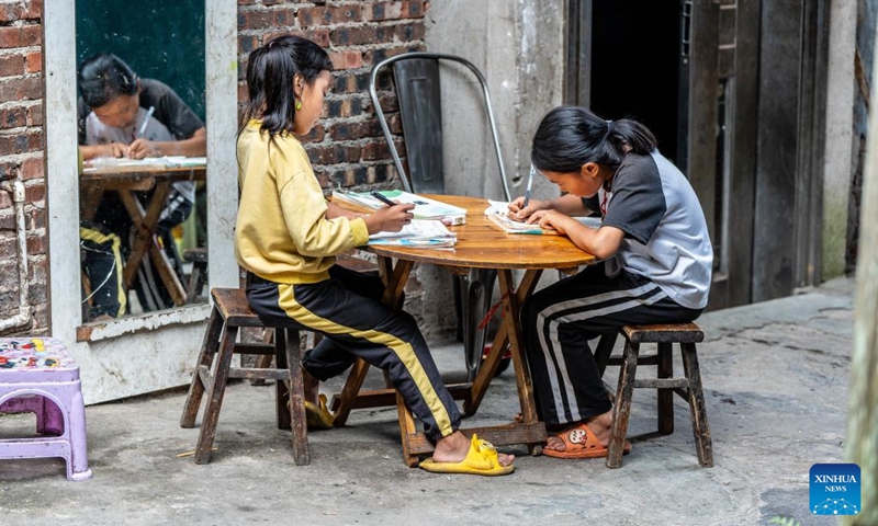 Children do homework at home in Basha Village, Congjiang County of Qiandongnan Miao and Dong Autonomous Prefecture, southwest China's Guizhou Province, Aug. 16, 2024. Photo: Xinhua