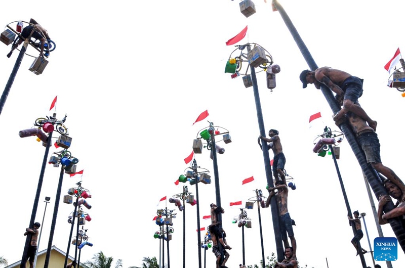 People participate in a greasy pole climbing game during the celebration of the 79th Independence Day at Ancol beach in Jakarta, Indonesia, Aug. 17, 2024. Indonesia celebrated its 79th Independence Day on Saturday. Photo: Xinhua