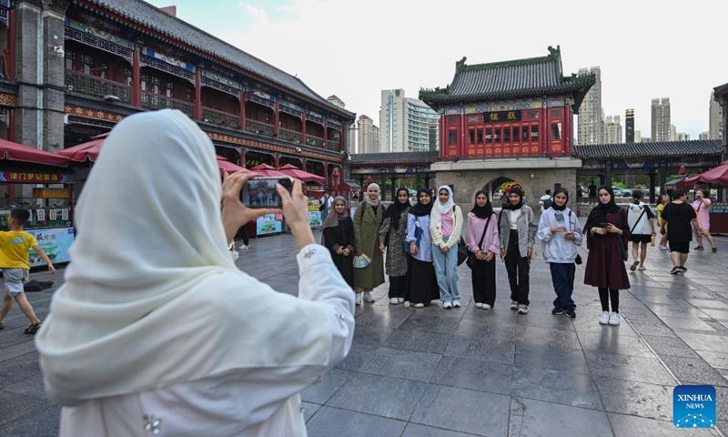 Omani youngsters pose for a group photo at a scenic spot in north China's Tianjin Municipality, Aug. 12, 2024. Twenty-two youngsters from Oman are on a two-week study tour in Beijing and Tianjin to experience the Chinese culture. Photo: Xinhua