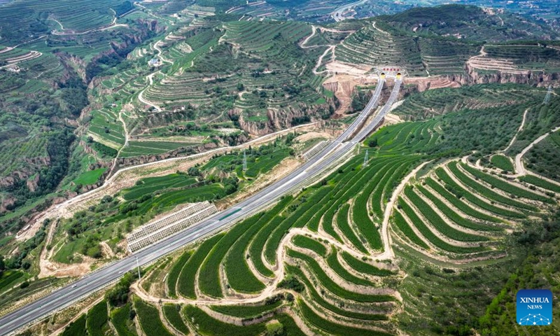 This aerial drone photo taken on Aug. 16, 2024 shows vehicles running along the Yinchuan-Kunming highway in northwest China's Ningxia Hui Autonomous Region. A section of the Yinchuan-Kunming highway within Ningxia, from Taiyangshan development zone to Pengyang, was completed and opened to traffic on Friday, marking the full opening of the Yinchuan-Kunming highway. The highway linking Yinchuan of northwest China's Ningxia Hui Autonomous Region and Kunming of southwest China's Yunnan Province, spans 2322 kilometers. Photo: Xinhua