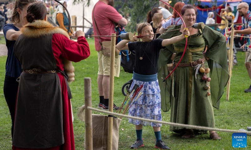 A girl practices archery at the Hame Medieval Festival in Hameenlinna, Finland on Aug. 17, 2024. The southern Finnish city of Hameenlinna hosted the Hame Medieval Festival, one of Finland's largest historical festivals, on the picturesque lakeside meadow beside Hame Castle from Aug. 16 to 18. Photo: Xinhua