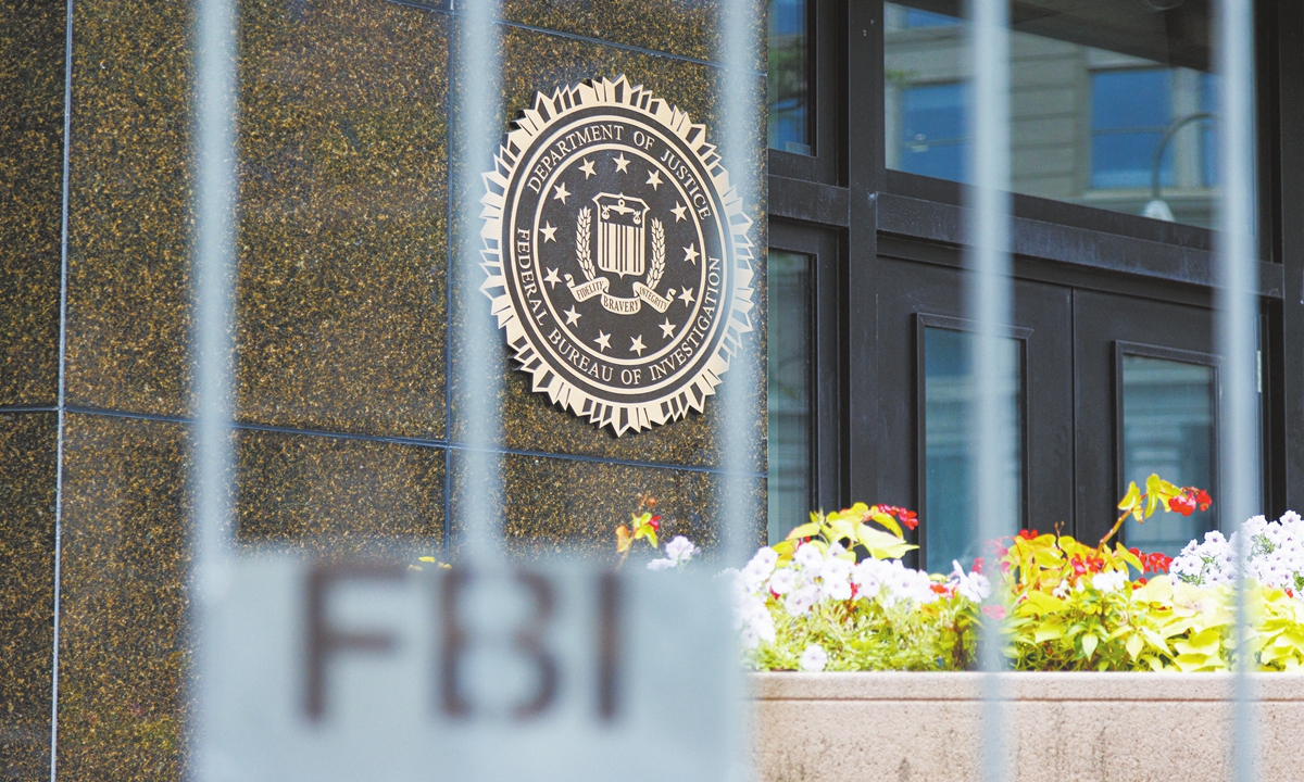 The seal of the FBI is seen on a wall at FBI Headquarters beyond new security fencing in Washington, DC on August 14, 2022. Photo: AFP