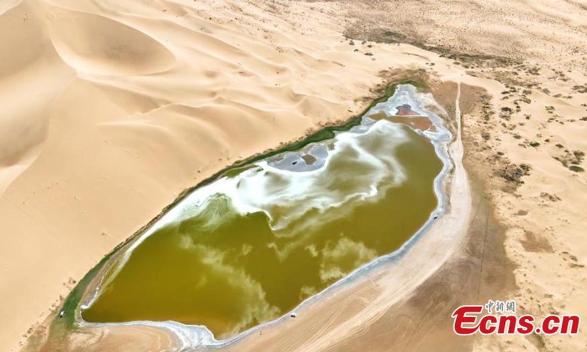 Scenery of the Badain Jaran desert in Alshaa league, north China's Inner Mongolia Autonomous Region. Sapphire-blue lakes coexist with high and low sand hills, presenting an interesting blend of barren and lush landscapes. Photo: China News Service
