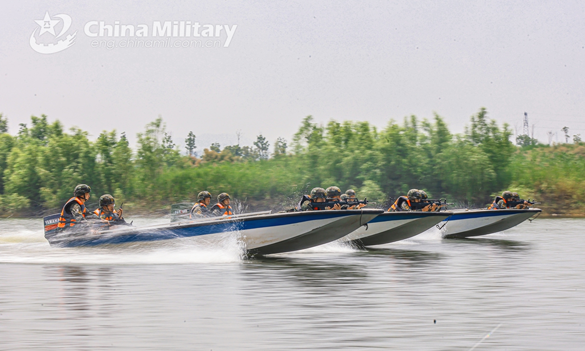 Assault boats attached to a reconnaissance element of the First Mobile Contingent of the People's Armed Police (PAP) Force sail rapidly towards the designated area during an aquatic shooting training exercise on July 4, 2024. (eng.chinamil.com.cn/Photo by Lan Weidong)