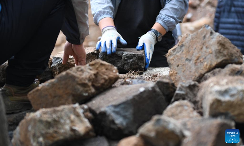 Bricks are seen at an archaeological site of a defense tower of the Jiankou section of the Great Wall in Beijing, capital of China, July 2, 2024. Covering six defense towers, from No. 117 to No. 122, the fifth phase of the Jiankou section of the Great Wall repair project has progressed smoothly. Beijing has pioneered Great Wall archaeological research, which precedes the repair work. The Jiankou section and the Dazhuangke section in Yanqing District have been selected as pilot projects to promote research-oriented restoration and protection of the Great Wall. Photo: Xinhua