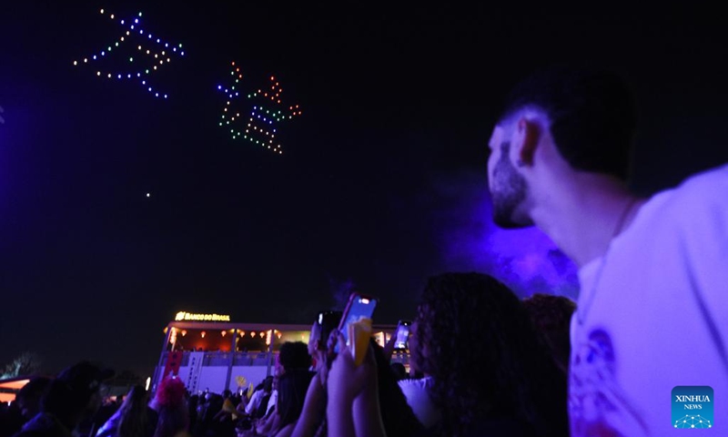 People watch a drone light show during the Na Praia Festival-China Day in Brazilia, Brazil on Aug. 17, 2024. This event was held here on Saturday in commemoration of the 50th anniversary of the establishment of diplomatic relations between China and Brazil. Photo: Xinhua