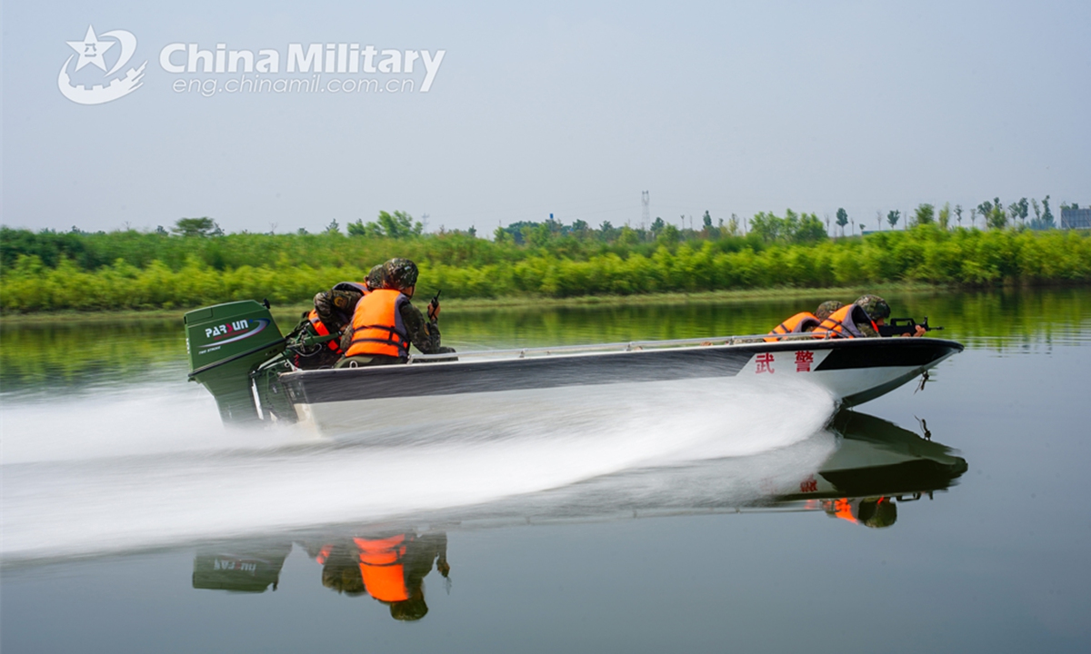 An assault boat attached to a reconnaissance element of the First Mobile Contingent of the People's Armed Police (PAP) Force sails rapidly towards the designated area during an aquatic shooting training exercise on July 4, 2024. (eng.chinamil.com.cn/Photo by Lan Weidong)