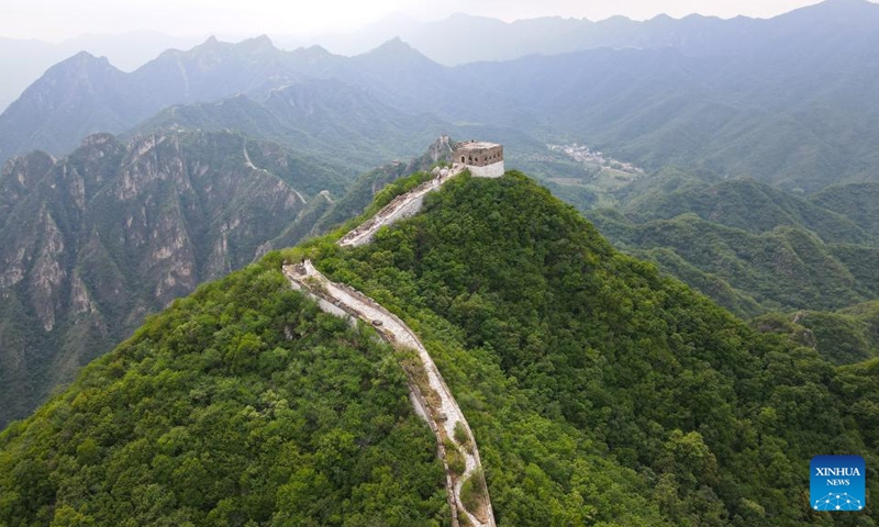 An aerial drone photo shows walls to be restored near a defense tower of the Jiankou section of the Great Wall in Beijing, capital of China, July 1, 2024. Covering six defense towers, from No. 117 to No. 122, the fifth phase of the Jiankou section of the Great Wall repair project has progressed smoothly. Beijing has pioneered Great Wall archaeological research, which precedes the repair work. The Jiankou section and the Dazhuangke section in Yanqing District have been selected as pilot projects to promote research-oriented restoration and protection of the Great Wall. Photo: Xinhua