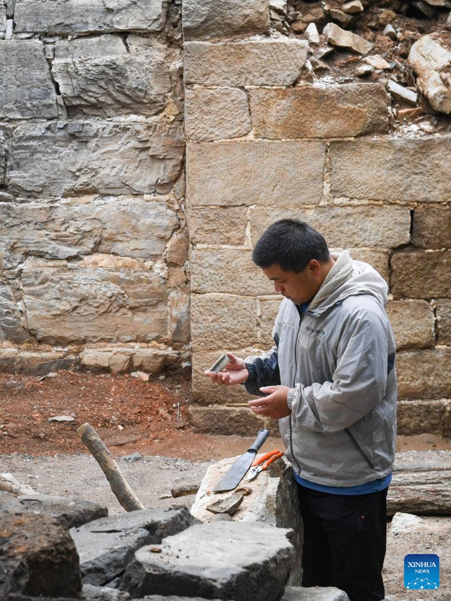 Technician Yang Zhanjie checks a piece of porcelain unearthed near a defense tower of the Jiankou section of the Great Wall in Beijing, capital of China, July 2, 2024. Covering six defense towers, from No. 117 to No. 122, the fifth phase of the Jiankou section of the Great Wall repair project has progressed smoothly. Beijing has pioneered Great Wall archaeological research, which precedes the repair work. The Jiankou section and the Dazhuangke section in Yanqing District have been selected as pilot projects to promote research-oriented restoration and protection of the Great Wall. Photo: Xinhua