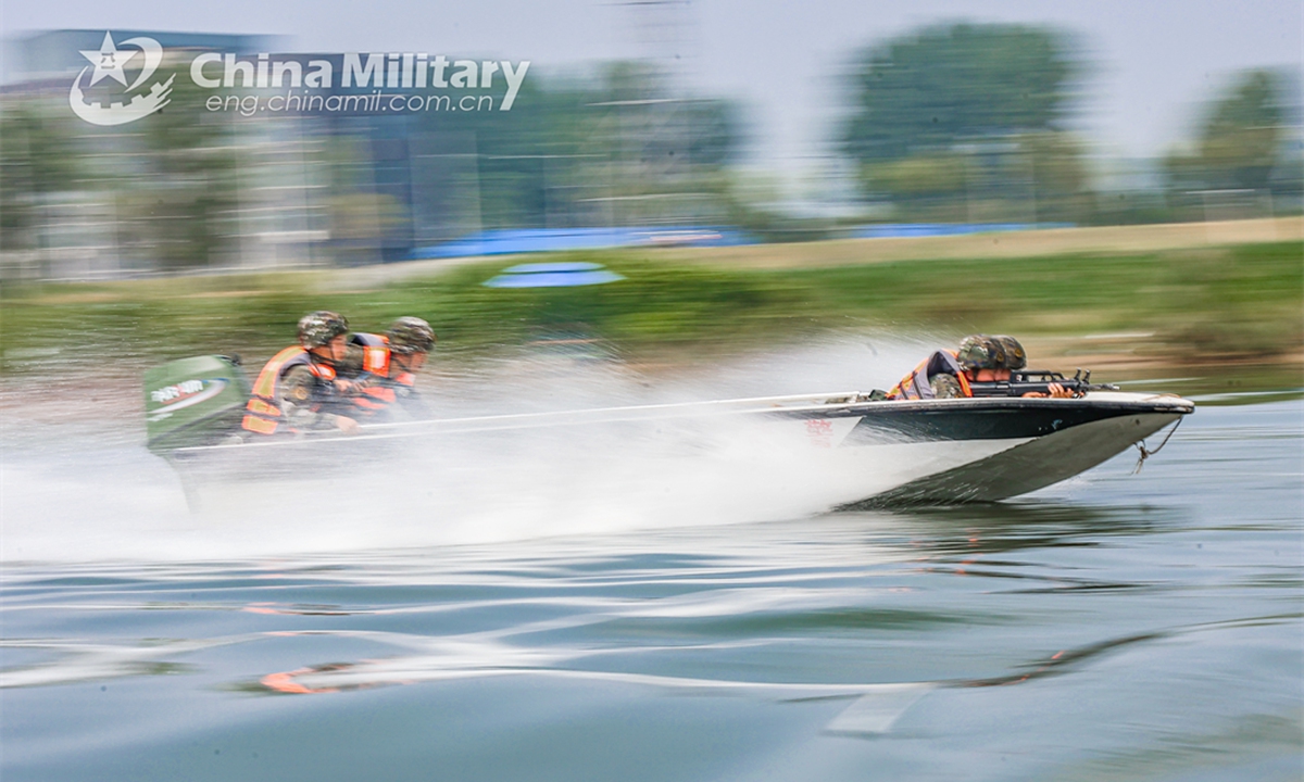 An assault boat attached to a reconnaissance element of the First MobileContingent of the People's Armed Police (PAP) Force sails rapidly towards the designated area during an aquatic shooting training exerciseon July 4, 2024. (eng.chinamil.com.cn/Photo by Lan Weidong)