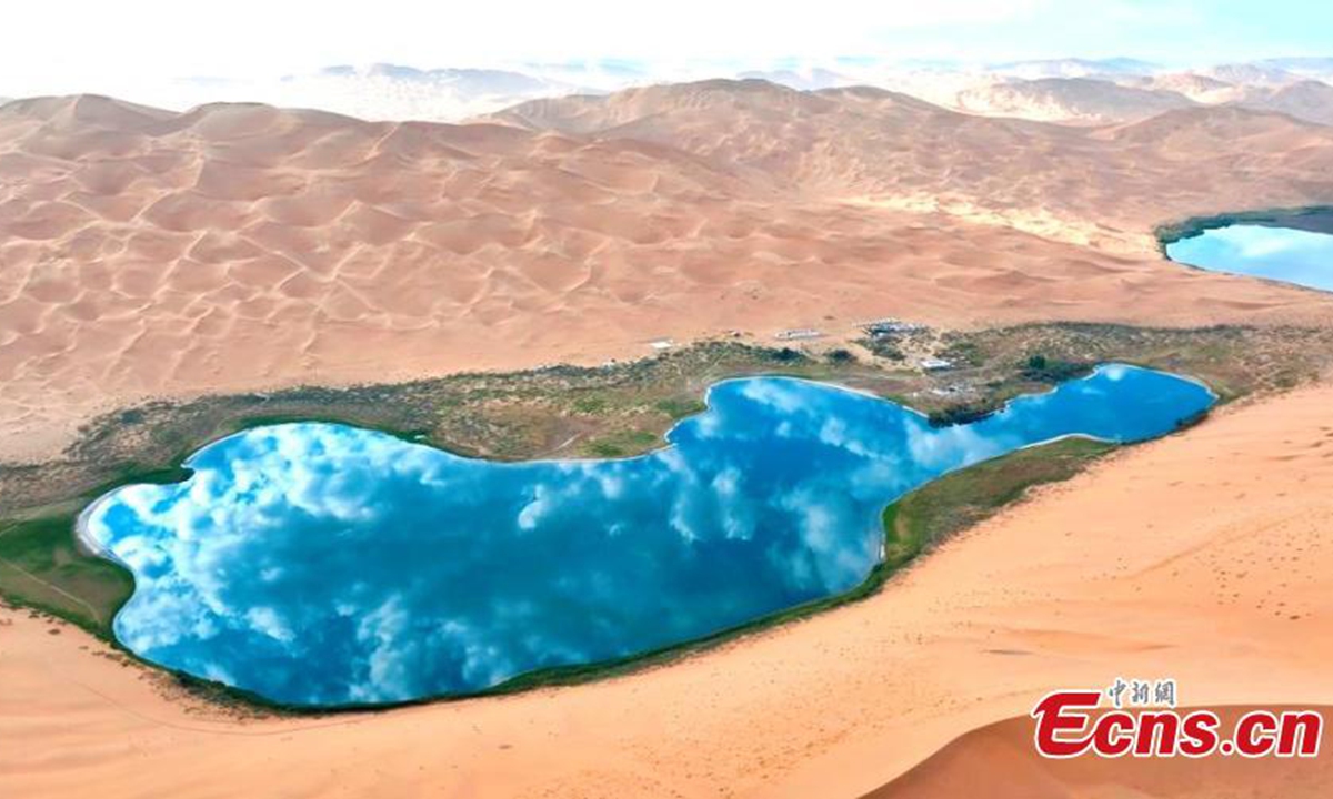 Scenery of the Badain Jaran desert in Alshaa league, north China's Inner Mongolia Autonomous Region. Sapphire-blue lakes coexist with high and low sand hills, presenting an interesting blend of barren and lush landscapes. Photo: China News Service
