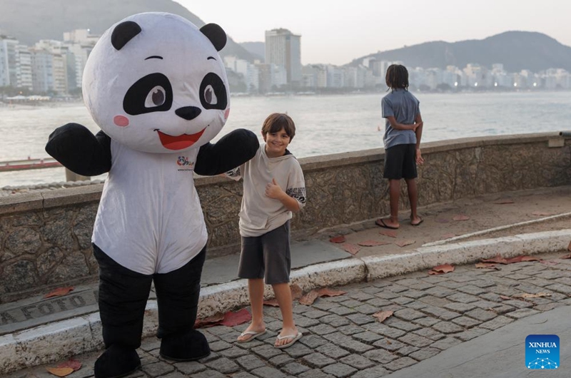 A boy poses for a photo with a panda mascot at the Copacabana Fort in Rio de Janeiro, Brazil, Aug. 17, 2024. The 50 Years of China-Brazil Friendship celebration was held here Saturday. Photo: Xinhua