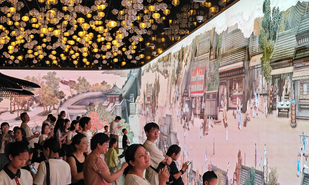 Visitors in Nanjing, East China's Jiangsu Province, enjoy a digital art exhibition on August 19, 2024. The exhibition incorporates cutting-edge technology into a painting by artist Feng Ning from the Qing Dynasty (1644-1911), vividly presenting an interactive exhibition on a screen nearly 110 meters long. Photo: IC 