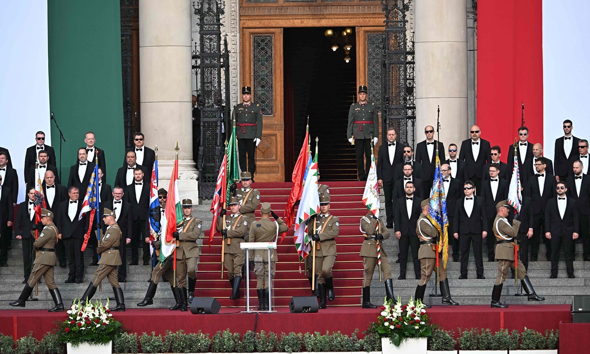 Honour guards march with historical Hungarian flags during the flag-raising ceremony as part of the celebrations marking the country's National Day on August 20, 2024, in front of the parliament building in Budapest. Hungary is marking the 1,024th anniversary of the foundation of the Hungarian state, established by the first king of Hungary, Stephen I in the year 1,000. Photo: VCG