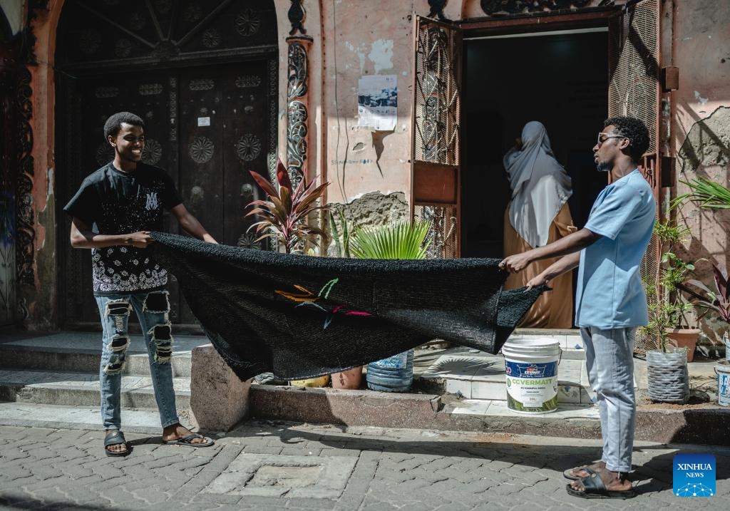 People clean a carpet in the Old Town of Mombasa, Kenya, on Aug. 17, 2024. The Old Town of Mombasa, located on the southeast side of Mombasa Island, has become an important tourist destination in Kenya due to its diverse culture and historical sites. (Photo: Xinhua)