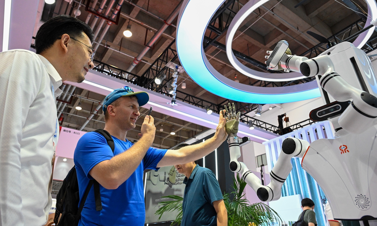 Exhibition visitors interact with a humanoid robot at the World Robot Conference 2024, which kicked off in Beijing on August 21, 2024. More than 600 items from 169 companies are on display, including 27 humanoid robots. (See story on Page 10) Photo: Chen Tao/GT 