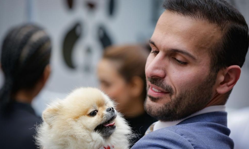 A dog owner holds his dog during the Pet-A-Palooza event in Vancouver, British Columbia, Canada, Aug. 25, 2024.

Pet-A-Palooza, also known as the Day of the Dog, is an annual summer celebration for local pups and their owners. This year's event offered a variety of dog-related activities and entertainment, attracting thousands of dog owners and their furry companions. (Photo by Liang Sen/Xinhua)