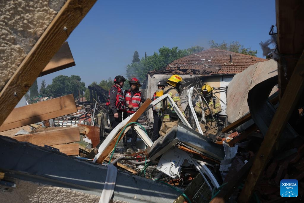 Members of Israeli emergency service work at a house directly hit by a rocket from Lebanon, in Katzrin of Israeli-annexed Golan Heights, on Aug. 21, 2024. Lebanese militant group Hezbollah fired at least 50 rockets at northern Israel Wednesday morning after Israeli warplanes struck several areas overnight and in the morning in Lebanon, killing at least three people, according to Israeli and Lebanese sources. (Photo: Xinhua)