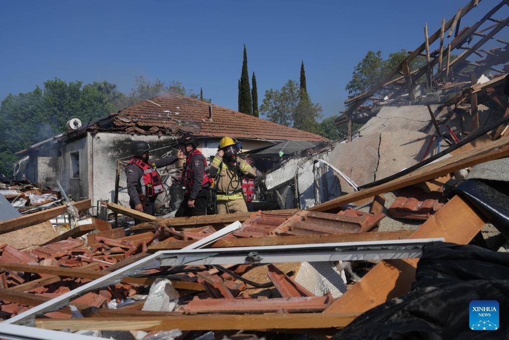 Members of Israeli emergency service work at a house directly hit by a rocket from Lebanon, in Katzrin of Israeli-annexed Golan Heights, on Aug. 21, 2024. Lebanese militant group Hezbollah fired at least 50 rockets at northern Israel Wednesday morning after Israeli warplanes struck several areas overnight and in the morning in Lebanon, killing at least three people, according to Israeli and Lebanese sources. (Photo: Xinhua)