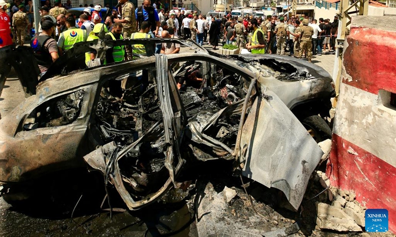 People gather near a vehicle destroyed by missiles from an Israeli drone in Sidon, Lebanon, on Aug. 21, 2024. An Israeli drone fired two air-to-surface missiles at a civilian SUV at the southern entrance to the city of Sidon on Wednesday morning, killing a leader in the Al-Aqsa Martyrs Brigades, the armed wing of the Palestinian National Liberation Movement (Fatah), Lebanese military sources told Xinhua. (Photo: Xinhua)