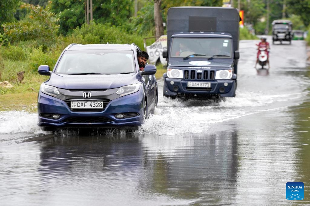 Vehicles ride on a waterlogged road in Gampaha, Sri Lanka, Aug. 21, 2024. (Photo: Xinhua)