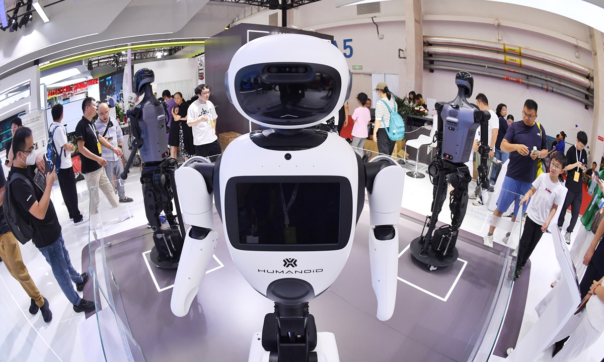 Robot Tianyi, white, stands with silver black Tiangong 1.2 MAX robots at the World Robot Conference 2024 on August 22, 2024. Tianyi is 163 centimeters tall, and as a service robot it can identify emotions and interact with people. Tiangong 1.2 MAX, 173 centimeters tall, can carry heavier items, walk faster and longer compared with its previous version 1.1 PRO. Photo: VCG